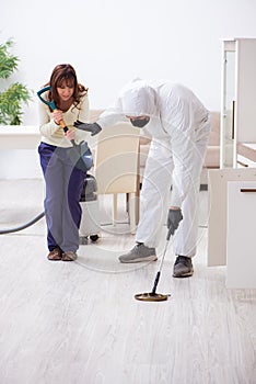 Young male contractor exterminating snakes in the flat