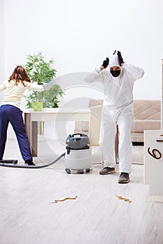 Young male contractor exterminating snakes in the flat