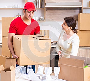 Young male contractor and female customer in moving concept