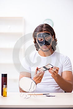 Young male cosmetician recording video for his blog