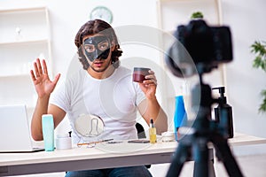 Young male cosmetician recording video for his blog