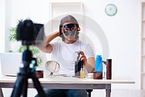 Young male cosmetician recording video for his blog