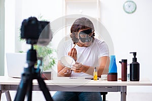 Young male cosmetician recording video for his blog