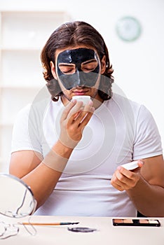 Young male cosmetician recording video for his blog