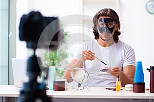 Young male cosmetician recording video for his blog