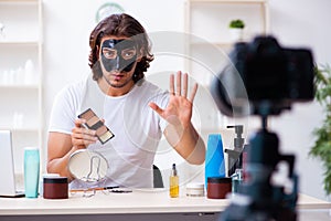 Young male cosmetician recording video for his blog