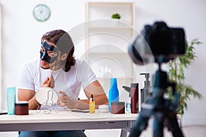 Young male cosmetician recording video for his blog