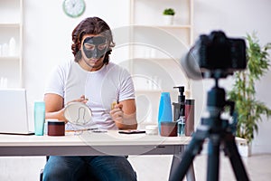 Young male cosmetician recording video for his blog