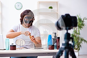 Young male cosmetician recording video for his blog