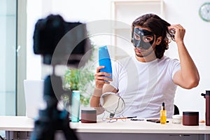 Young male cosmetician recording video for his blog