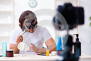 Young male cosmetician recording video for his blog