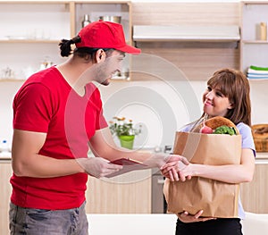 Young male courier in food delivery concept