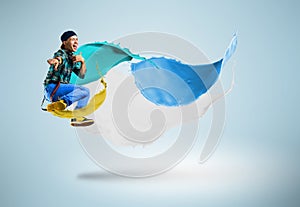 Young male dancer jumping with splash of paint