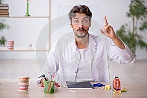 Young male dentist working in the clinic