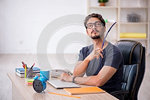 Young male designer working in the office