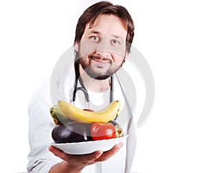 Young male doctor advicing healthy natural food photo