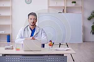 Young male doctor cardiologist in the classroom