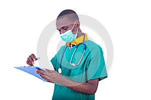 Young male doctor checking notes on clipboard