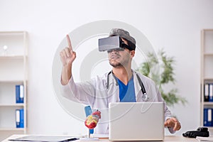 Young male doctor enjoying virtual glasses in the clinic