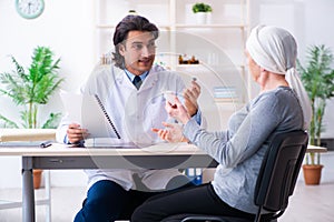 Young male doctor and female oncology patient