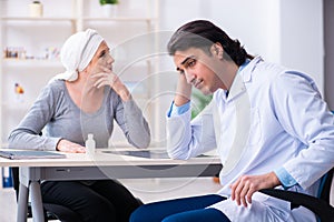 Young male doctor and female oncology patient