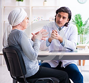 Young male doctor and female oncology patient