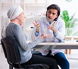 Young male doctor and female oncology patient