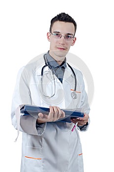 Young male doctor in glasses, standing with a ballpoint pen in hand and ECG. Looking at the camera.