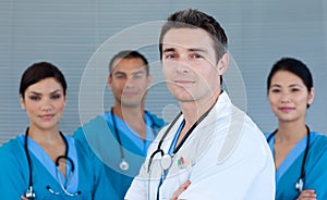 Young male Doctor with his team in the background