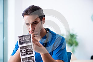 Young male doctor looking at doppler images