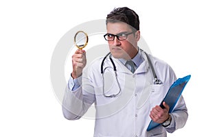 Young male doctor with a looking magnifying glass isolated on wh