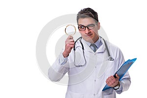 Young male doctor with a looking magnifying glass isolated on wh