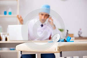 The young male doctor otolaryngologist working at the hospital