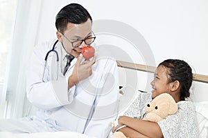 Young male doctor pediatrician checking girl