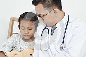 Young male doctor pediatrician checking girl