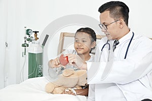 Young male doctor pediatrician checking girl