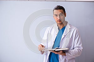 Young male doctor in presentation concept