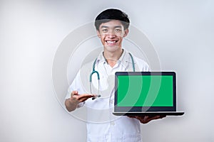 Young Male doctor showing green blank laptop screen