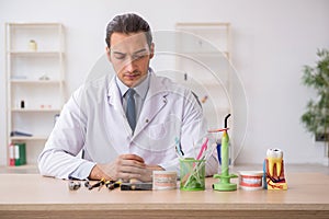 Young male doctor stomatologist working in the clinic