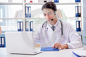The young male doctor in telehealth concept photo