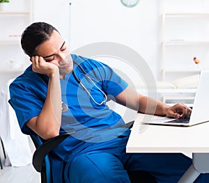 Young male doctor working in the clinic