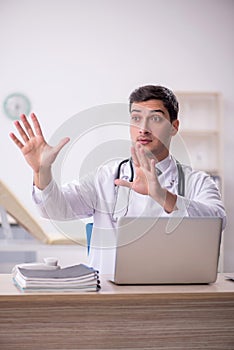 Young male doctor working at the hospital