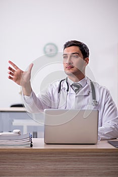 Young male doctor working at the hospital