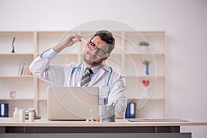 Young male doctor working at the hospital