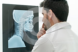 Young male doctor working with patient xray film.