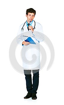 Young male doctor writing on a patient's medical chart