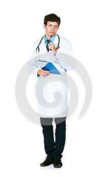 Young male doctor writing on a patient's medical chart photo