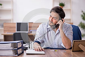 Young male drug addicted employee at workplace