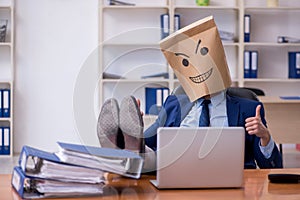 Young male employee with box instead of his head