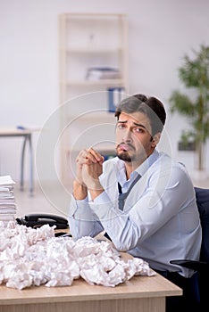 Young male employee in brainstorming concept